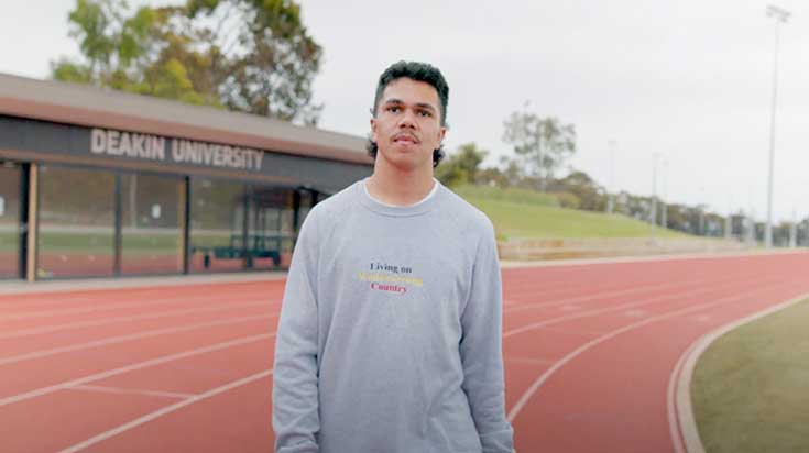 Jack Sampi, indigenous student walking along the running track at Waurn Ponds campus