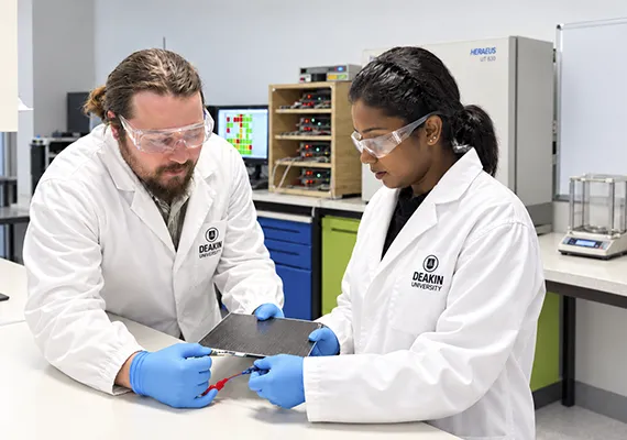 Bhagya Dharmisiri and James Randall holding a carbon fibre composite