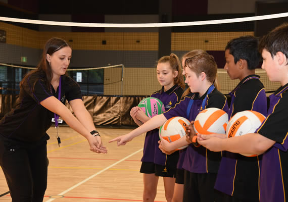 Health and physical education students kicking goals