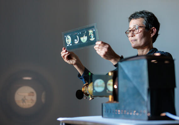 Dr Lienors Torre, Lecturer in Film and Animation, with glass lantern and glass slide.