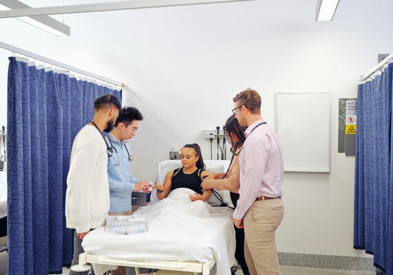 Deakin students examining a patient.