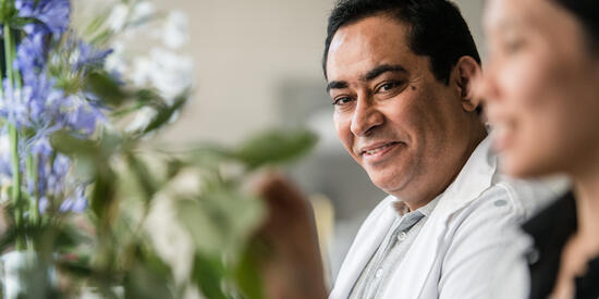 Staff member enjoys watching student interact with plant