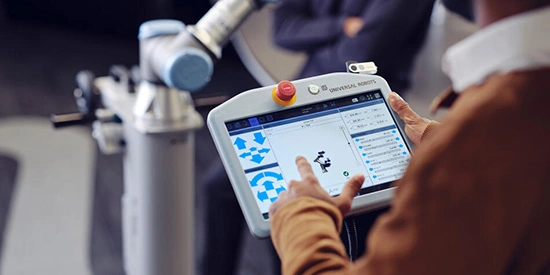 Student using a tablet to program a robot