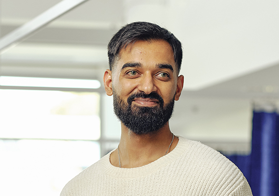 Deakin doctor of medicine student amrit smiling on campus.