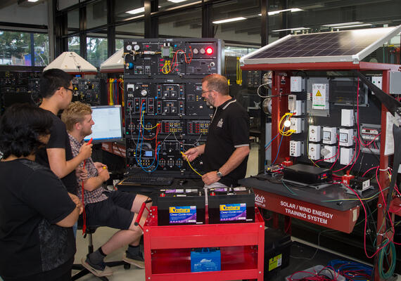 Students and technician using equipment