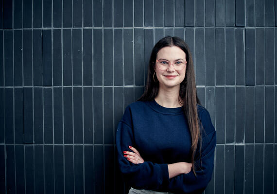 Student Lillian McLean standing in front of a wall.