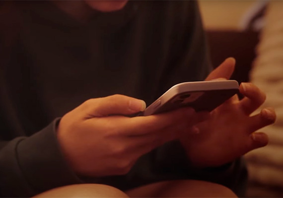 Deakin sport student holding a phone.
