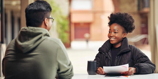 Student with papers in hand