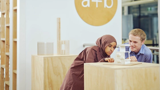 Two students look at an architectural model