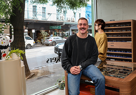 Jayson Stone in his office with one of his staff members.