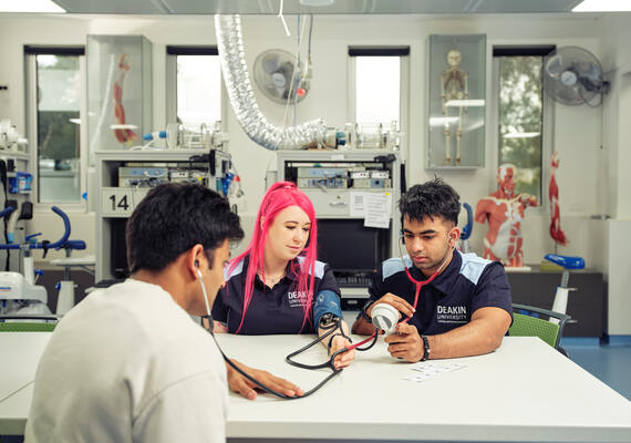 Three Deakin students working in the exercise and sports science building.