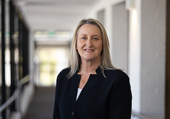 Chancellor Claire Higgins standing in a corridor at Deakin