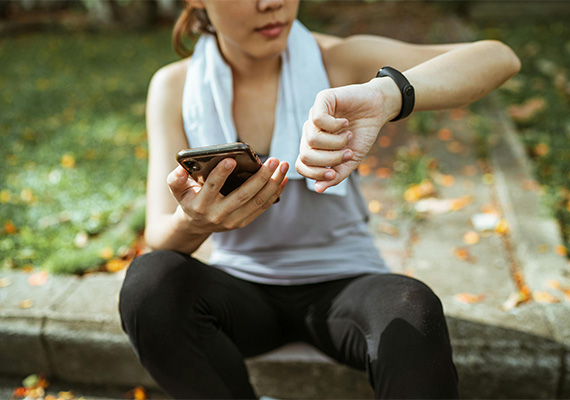 Woman using fitness tech during exercise