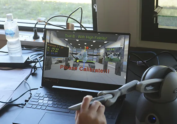 Student using a robot arm