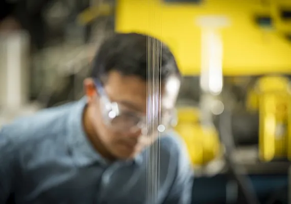 Melt extruded polymer coming from spinneret in lab