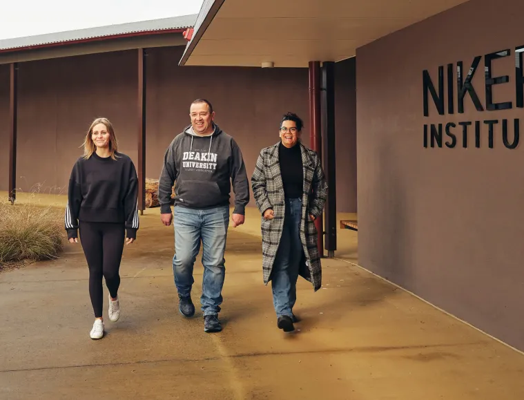 Three students walking outside NIKERI Institute at Deakin