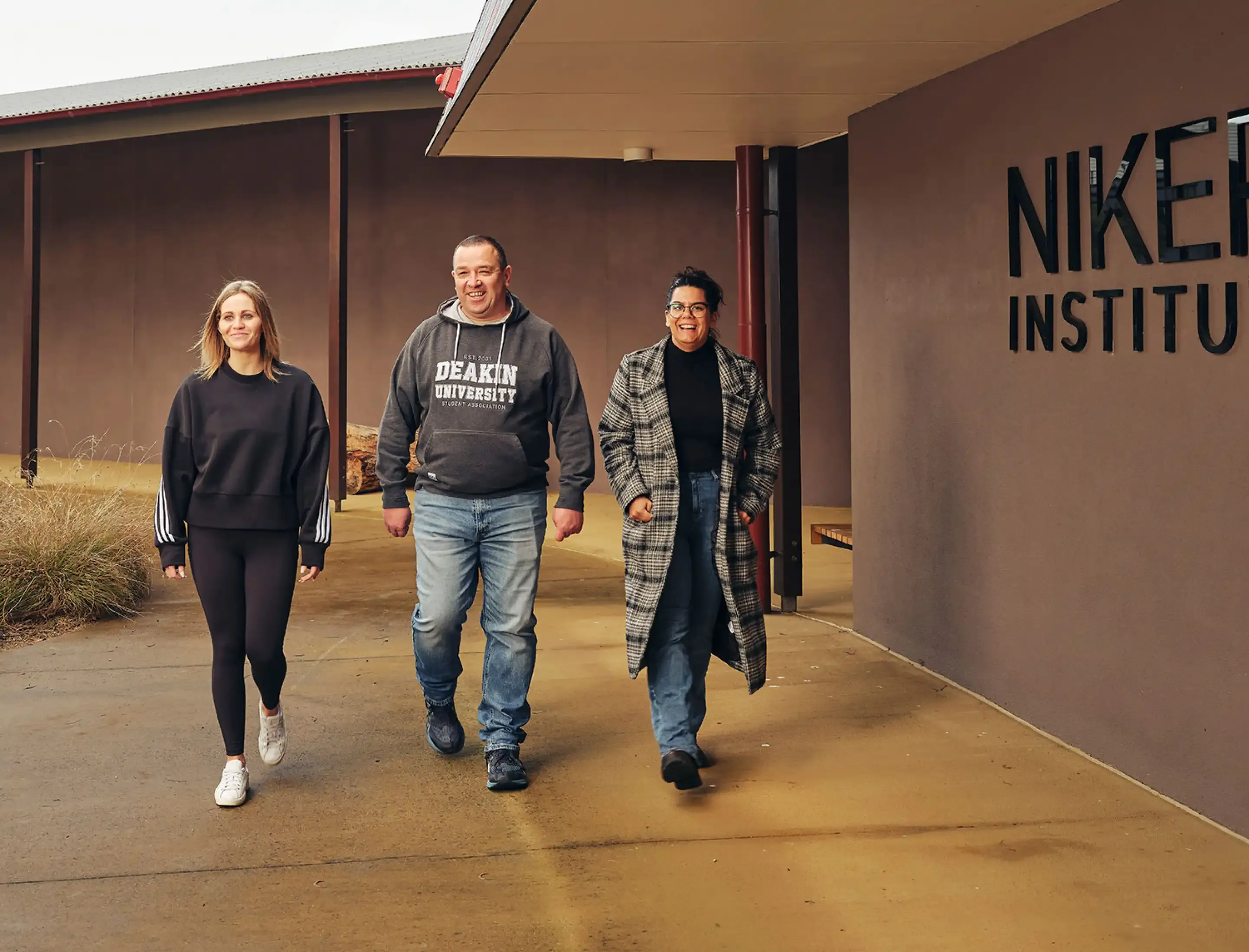 Three students walking outside NIKERI Institute at Deakin