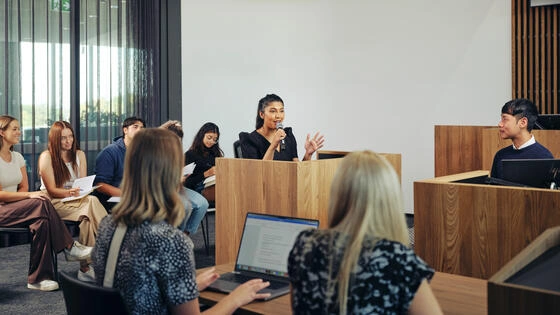 Deakin student presents to group of people.