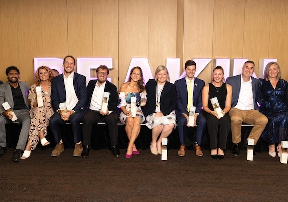 Group of Deakin alumni celebrating with trophies at the Deakin Alumni Awards