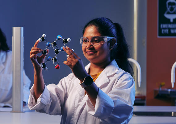 A Deakin science student looks at a model of a molecule