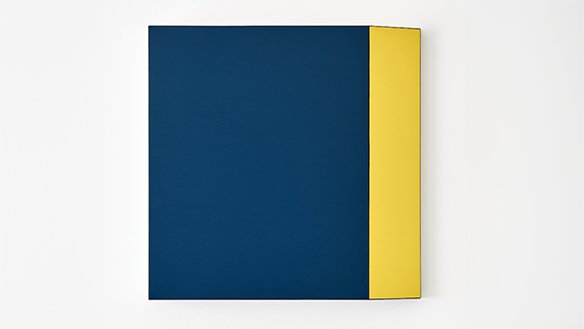 Abstract artwork featuring two blocks of highly saturated colour, with a dark blue to the majority of the left of the surface and yellow to the right of the surface, creating a horizontal stripe of yellow. The top and the bottom of the yellow stripe appears tapered inwards.