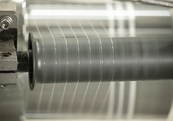 Single polymer filament strand being spun