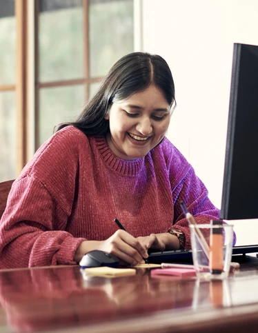 A student studies at a computer at home.