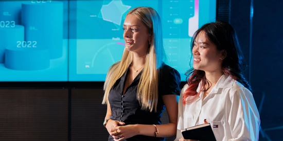 Two Deakin business and economics students walk around campus