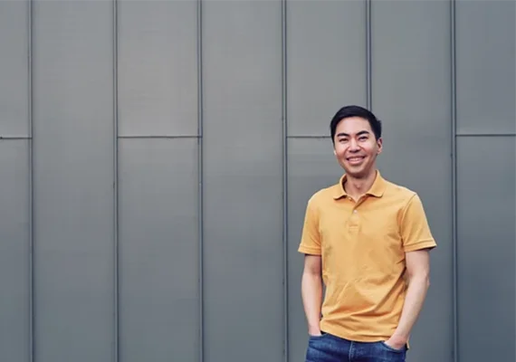 A Deakin student standing near the law building