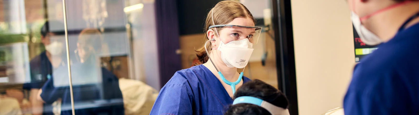 A Deakin postgraduate nursing student attends to a patient. 
