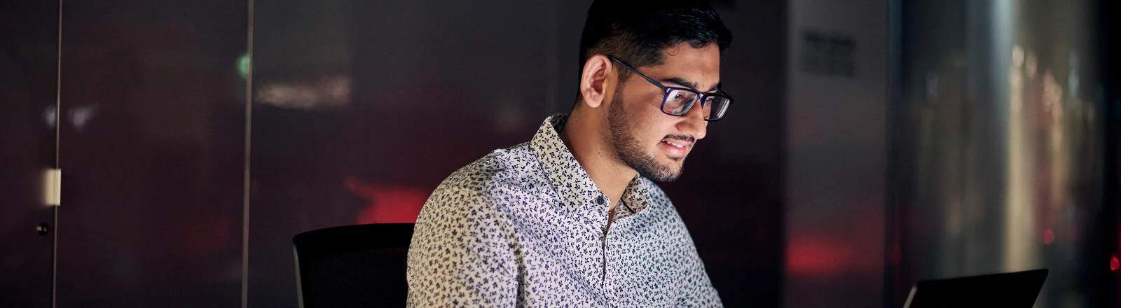 A Deakin master of cyber security student at a computer.