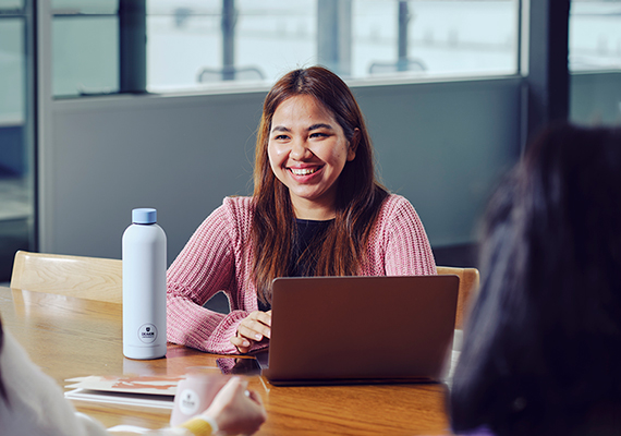 A Deakin student sits studying with a laptop.