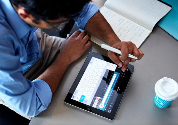 A Deakin student studying online with a tablet.