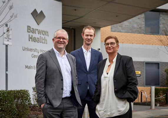 Three people outside Barwon Health University Hospital Geelong site