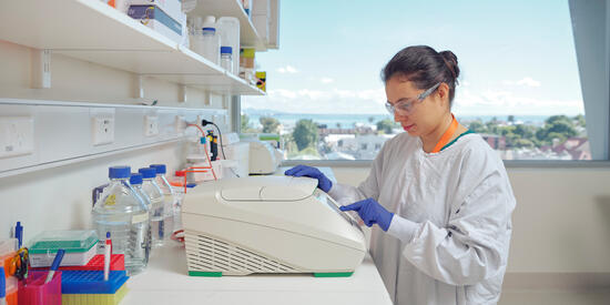 A Deakin health researcher uses lab equipment
