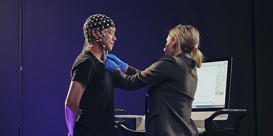 Deakin psychology student performing a test in a campus lab.