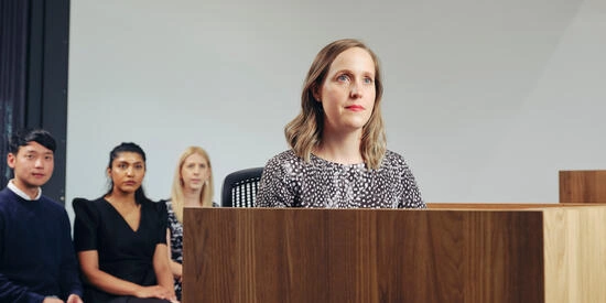 A Deakin law student standing at a lectern.