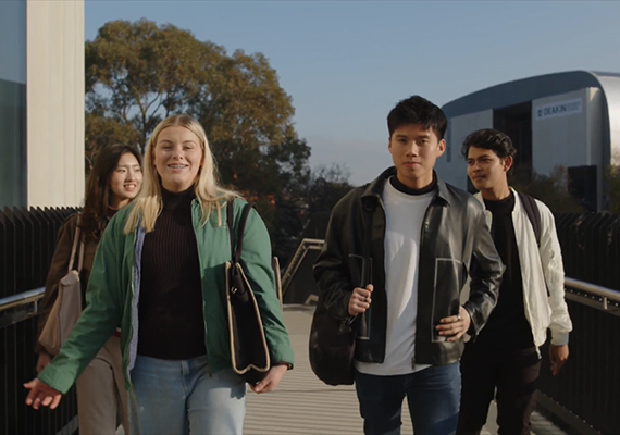 Four business students walking to class at Deakin's Burwood Campus.