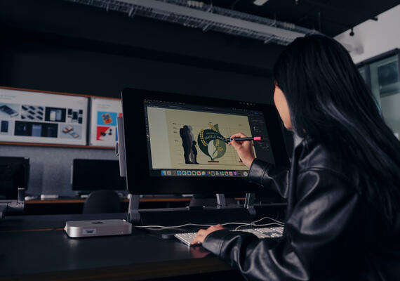 Deakin design student sits at a computer while working on a design project at the Melbourne Burwood Campus.