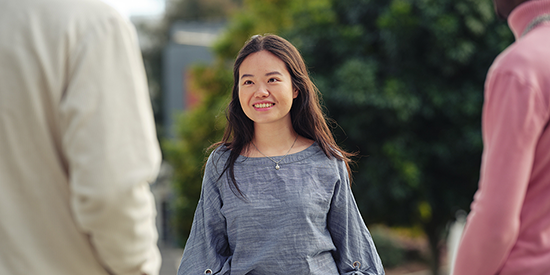 a student smiling on campus