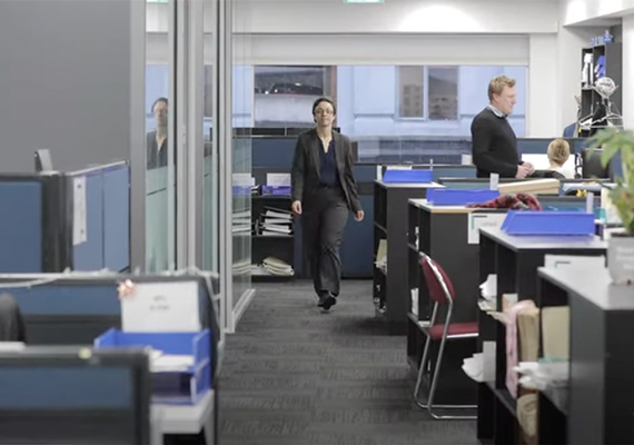 A person walking through a corporate office.