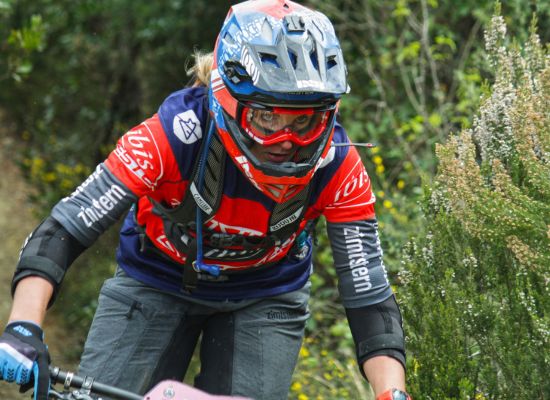A close up action photo of a female mountain bike rider
