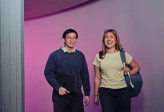 Students walking together along a curved hallway