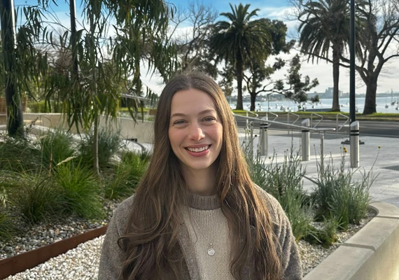 Deakin international studies student Georgia Lee smiling in front of trees on campus.