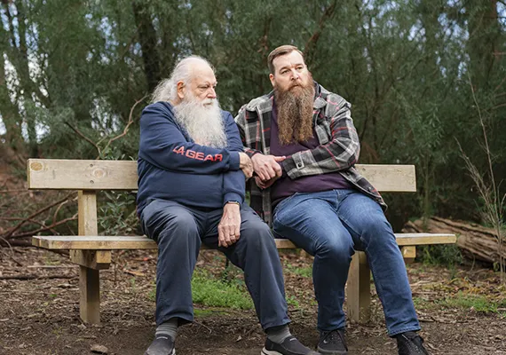 Al and Bryan Fricker sitting on bench together