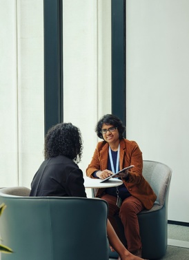 Teacher and student sitting and talking