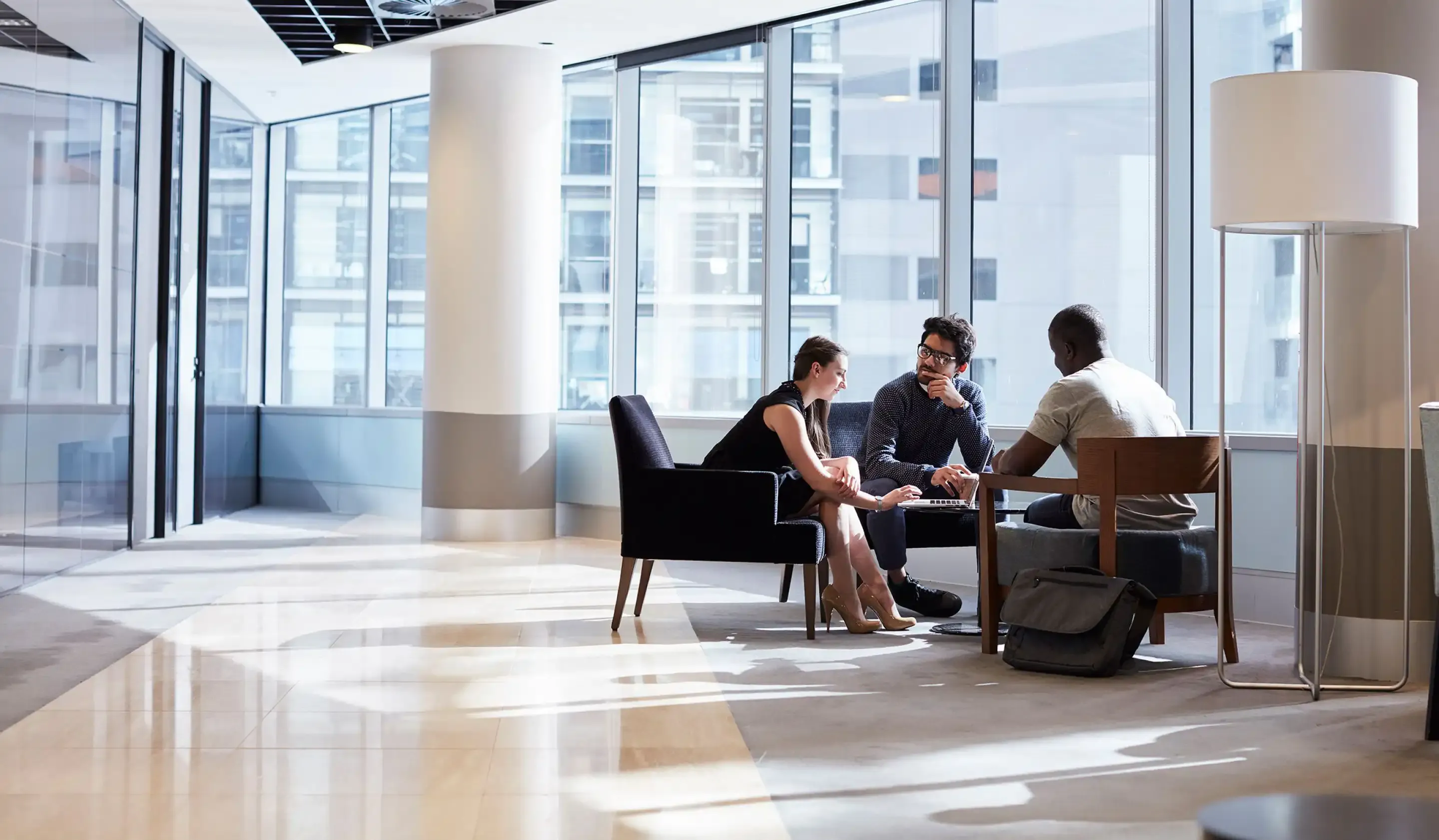 Three students in office at table