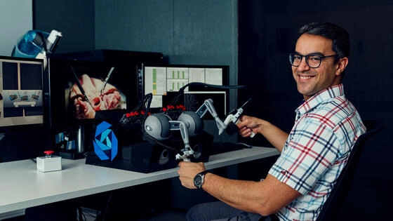 A Deakin Master of Engineering student with robotics.