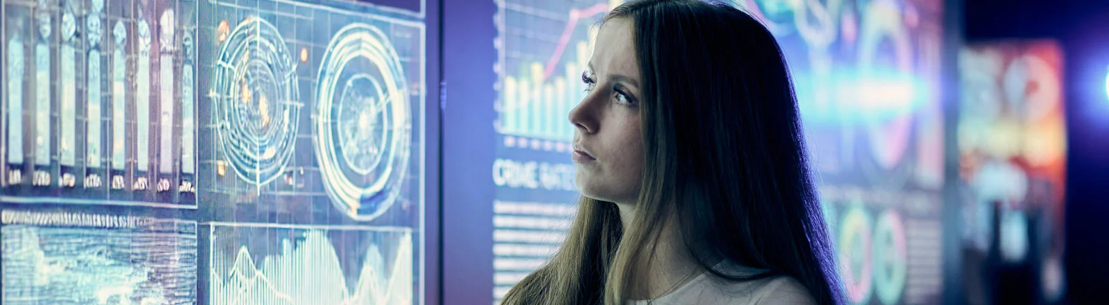 A Deakin postgraduate criminology student looks at data on a screen.