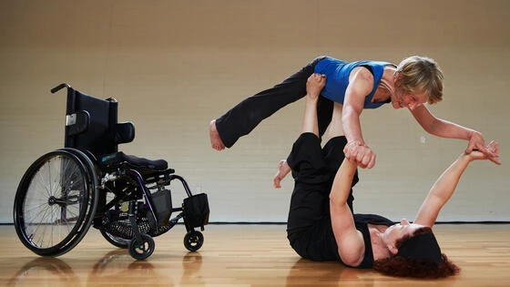 Deakin disability and Inclusion postgraduate student assisting with movements.